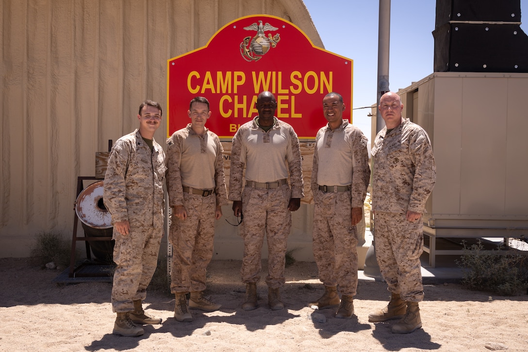 U.S. Navy chaplains with Marine Wing Support Squadron 472, Marine Aircraft Group 49, 4th Marine Aircraft Wing and 25th Marine Regiment, 4th Marine Division pose for a group photo during Integrated Training Exercise 3-25 (ITX 3-25) at Marine Corps Air Ground Combat Center, Twentynine Palms, California, June 18th, 2025. Chaplains develop force readiness by guiding Marines both spiritually and mentally in harsh environments. ITX is a critical Marine Air-Ground Task Force exercise for the Marine Forces Reserve’s training cycle, confirming unit readiness through live-fire and combined arms integration. (U.S. Marine Corps photo by Lance Cpl. Edward Spears)