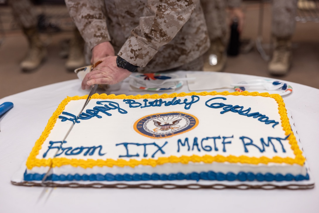 U.S. Marine Corps Command Master Chief Petty Officer Matthew R. Paul, command master chief of 4th Marine Division, cuts a birthday cake as part of a celebration of the Navy Corpsman 127th birthday during Integrated Training Exercise 3-25 (ITX 3-25) on Marine Corps Air Ground Combat Center, Twentynine Palms, California, June 17, 2025. The Hospital Corps is the most decorated corps in the Navy and was established on June 17, 1898. It comprises more than 26,000 active duty and reserve hospital corpsman. ITX is a critical Marine Air-Ground Task Force exercise for the Marine Forces Reserve’s training cycle, confirming unit readiness through live-fire and combined arms integration. (U.S. Marine Corps photo by Staff Sgt. Scott Jenkins)