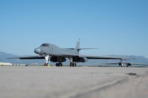 Two B-1B Lancer aircraft sit on the Peterson SFB flightline