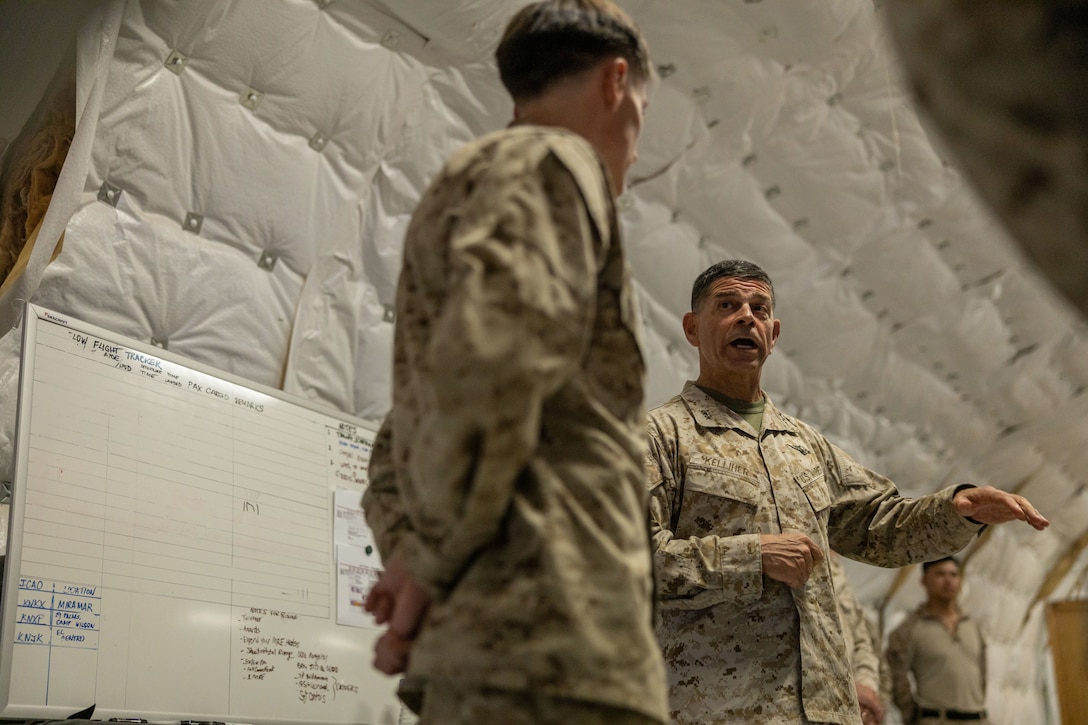 U.S. Marine Corps Sgt. Luis Sanchez Caceres of Marine Aircraft Group 49, 4th Marine Aircraft Wing (left), and Maj. Gen. John Kelliher, commanding general of 4th Marine Aircraft Wing, Marine Forces Reserve, discuss leadership development at Integrated Training Exercise 3-25, Marine Corps Air Ground Combat Center, Twentynine Palms, California, June 11, 2025. ITX is a critical Marine Air-Ground Task Force exercise for the Marine Forces Reserve’s training cycle, confirming unit readiness through live-fire and combined arms integration. (U.S. Marine Corps photo by Lance Cpl. Edward Spears)