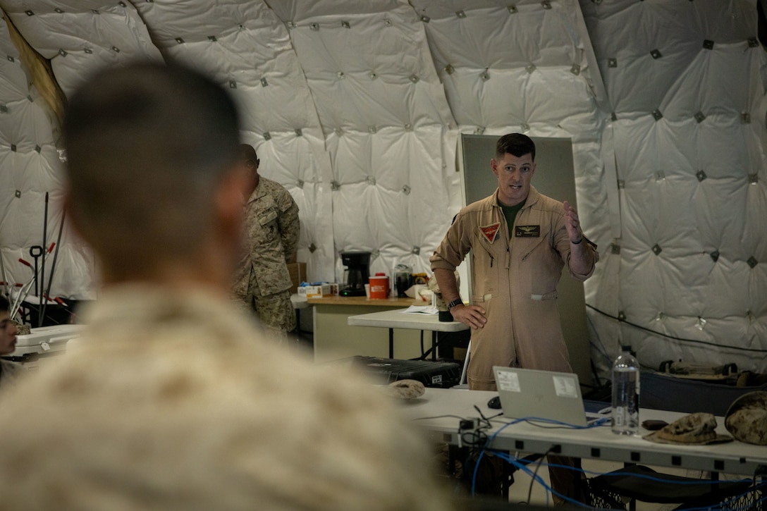 U.S. Marine Corps Maj. Gen. John Kelliher, commanding general of 4th Marine Aircraft Wing, Marine Forces Reserve (left), and Maj. Derek Cunningham of Marine Aircraft Group 49, 4th Marine Aircraft Wing, discuss operations at a Combat Operations Center at Integrated Training Exercise 3-25, Marine Corps Air Ground Combat Center, Twentynine Palms, California, June 11, 2025. ITX is a critical Marine Air-Ground Task Force exercise for the Marine Forces Reserve’s training cycle, confirming unit readiness through live-fire and combined arms integration. (U.S. Marine Corps photo by Lance Cpl. Edward Spears)