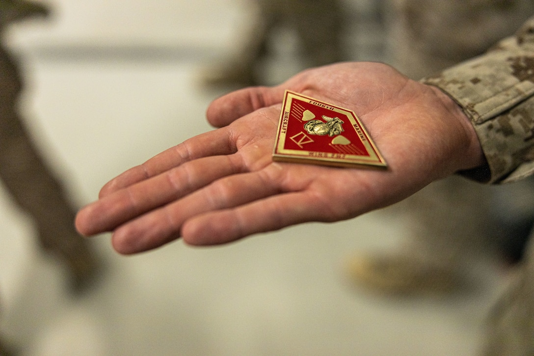 U.S. Marine Corps Sgt. Luis Sanchez Caceres of Marine Aircraft Group 49, 4th Marine Aircraft Wing, holds a challenge coin at Integrated Training Exercise 3-25, Marine Corps Air Ground Combat Center, Twentynine Palms, California, June 11, 2025. ITX is a critical Marine Air-Ground Task Force exercise for the Marine Forces Reserve’s training cycle, confirming unit readiness through live-fire and combined arms integration. (U.S. Marine Corps photo by Lance Cpl. Edward Spears)
