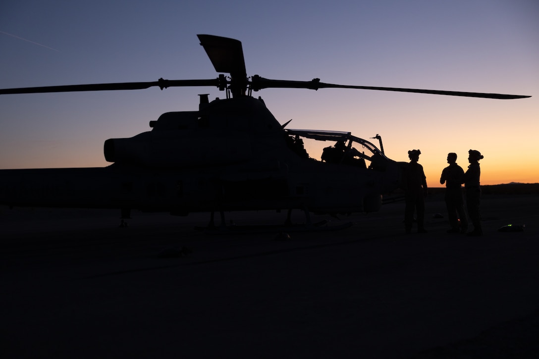 U.S. Marine Corps aviation ordnance technicians with Marine Light Attack Helicopter Squadron (HMLA) 773, 4th Marine Air Wing guide UH-1Y Venom helicopters to landing zone at ALZ Sandhill during Integrated Training Exercise 3-25 (ITX 3-25) at Marine Corps Air Ground Combat Center, Twentynine Palms, California, June 11th, 2025. ITX enhances Marines’ lethality by empowering leaders at every level to adapt, communicate, and execute dynamic movements in hostile environments. (U.S. Marine Corps photo by Lance Cpl. Edward Spears)