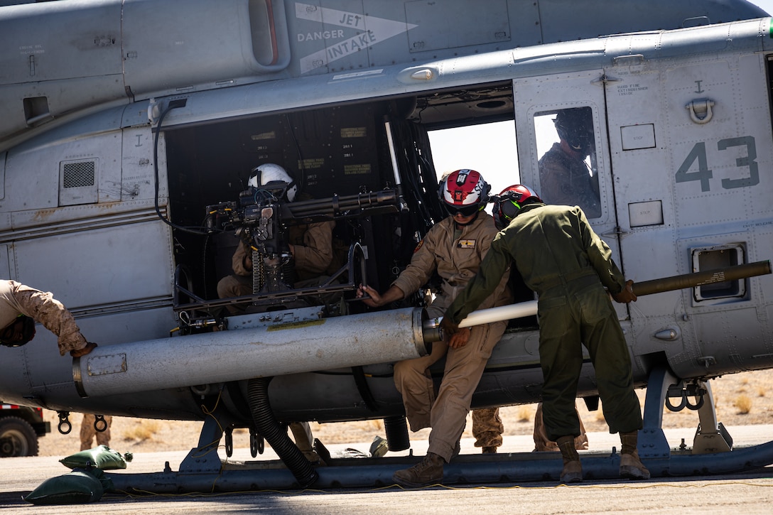 U.S. Marine Corps aviation ordnance technicians with Marine Light Attack Helicopter Squadron (HMLA) 773, 4th Marine Air Wing loads hydra 70 a 2.75-inch Rocket at ALZ Sandhill during Integrated Training Exercise 3-25 (ITX 3-25) at Marine Corps Air Ground Combat Center, Twentynine Palms, California, June 11th, 2025. ITX enhances Marines’ lethality by empowering leaders at every level to adapt, communicate, and execute dynamic movements in hostile environments. (U.S. Marine Corps photo by Lance Cpl. Edward Spears)