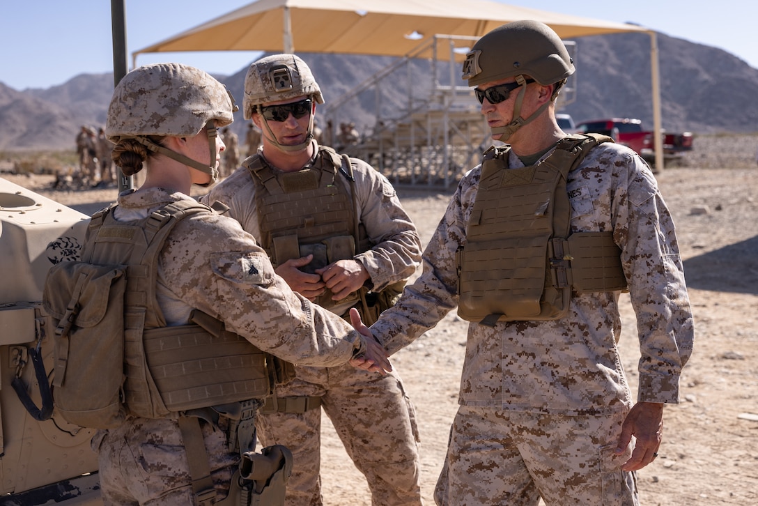 U.S. Marine Corps Lt. Gen. Leonard F. Anderson IV, commander of Marine Forces Reserve, speaks with Cpl. Kathryn Smith, a military police officer with 4th Law Enforcement Battalion, Force Headquarters Group, Marine Forces Reserve, during Integrated Training Exercise 3-25 (ITX 3-25) on Marine Corps Air Ground Combat Center, Twentynine Palms, California, June 14, 2025. ITX is a critical Marine Air-Ground Task Force exercise for the Marine Forces Reserve’s training cycle, confirming unit readiness through live-fire and combined arms integration. (U.S. Marine Corps photo by Staff Sgt. Scott Jenkins)