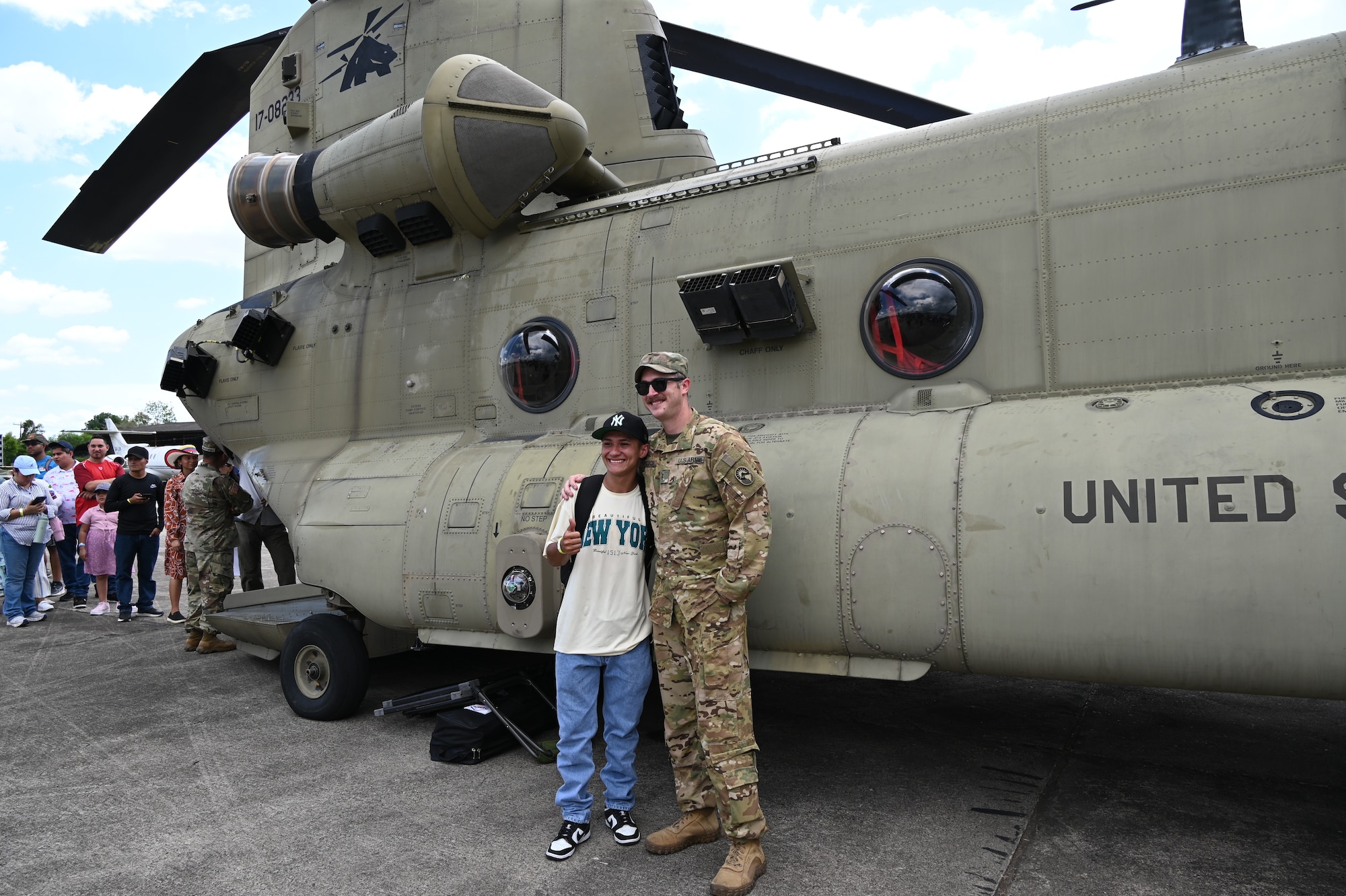 CH-47 Pilot, CW2 Dylan Mesch poses with a child during the Honduran Fuerza Aerea Air Show.