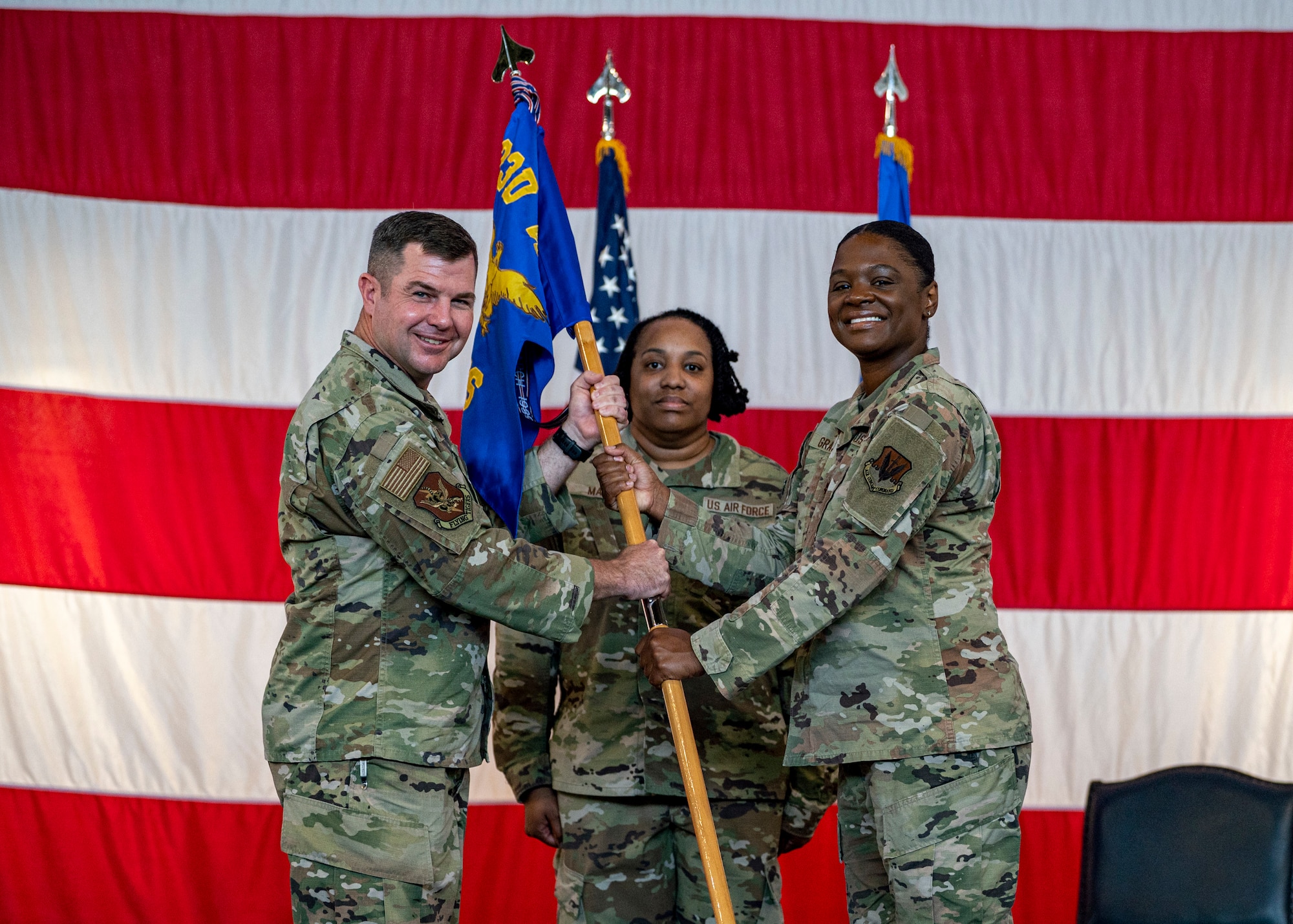 U.S. Air Force Maj. Avante Graves assumes command of the 23rd Comptroller Squadron as she receives the guidon from Col. Paul Sheets, 23rd Wing commander, during a change of command ceremony at Moody Air Force Base, Georgia, June 23, 2025. Passing the guidon represents a proud military tradition, marking the official transition of leadership and responsibility from one commander to the next. (U.S. Air Force photo by Senior Airman Leonid Soubbotine)