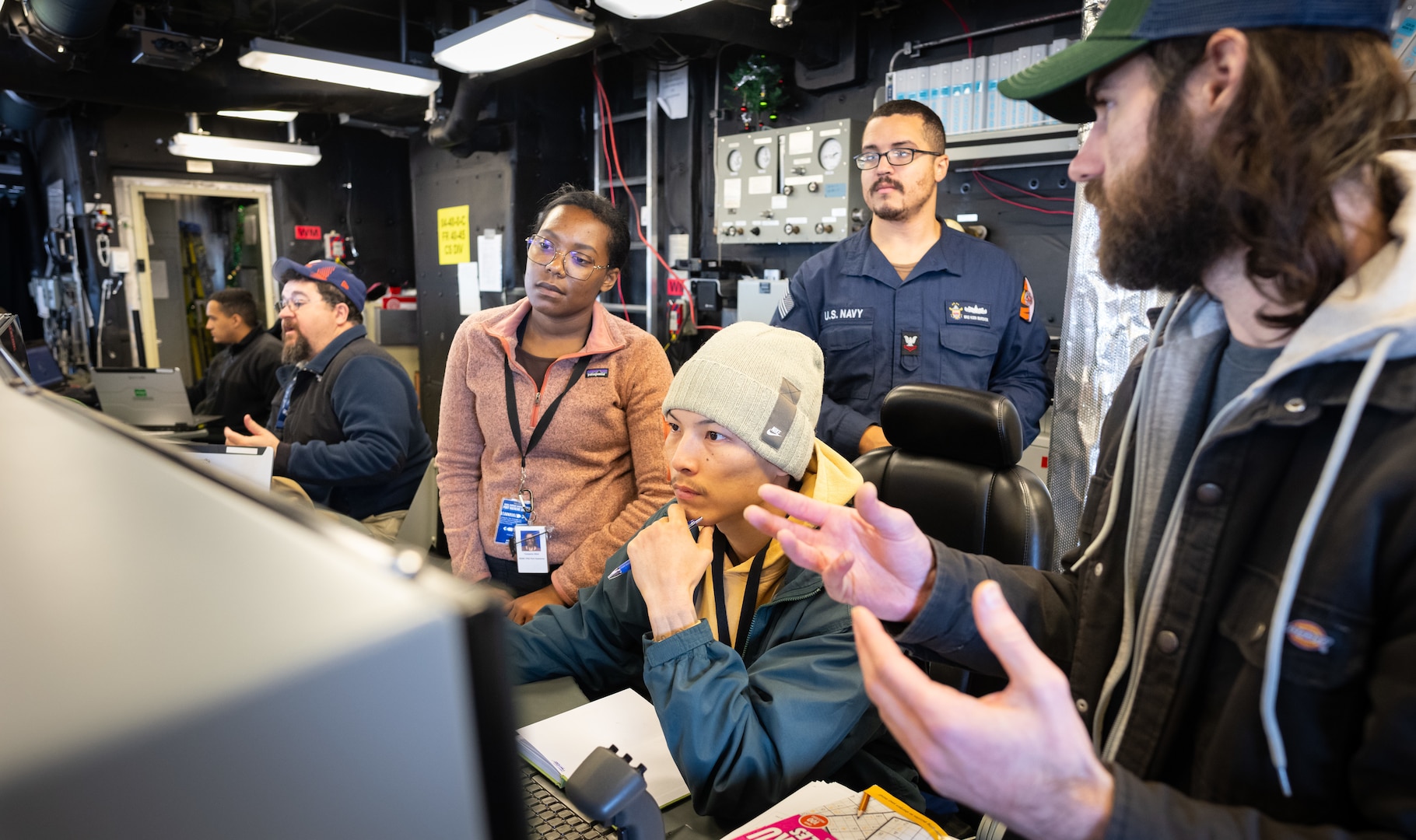 PORT HUENEME, Ca. — Naval Surface Warfare Center (NSWC) Dahlgren Division waterfront engineer David Vieira, second from left, works on the bridge of USS Cincinnati to ensure the Combat Information Center functions properly during a Combat Systems Assessment Team event at NSWC Port Hueneme Division in California. (Eric Parsons/U.S. Navy photo)