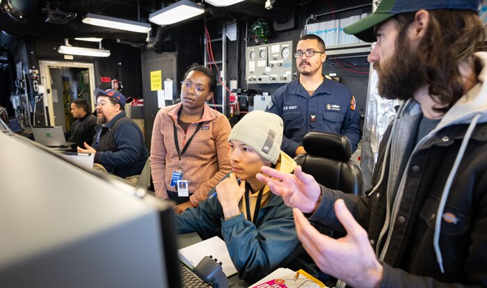 PORT HUENEME, Ca. — Naval Surface Warfare Center (NSWC) Dahlgren Division waterfront engineer David Vieira, second from left, works on the bridge of USS Cincinnati to ensure the Combat Information Center functions properly during a Combat Systems Assessment Team event at NSWC Port Hueneme Division in California. (Eric Parsons/U.S. Navy photo)