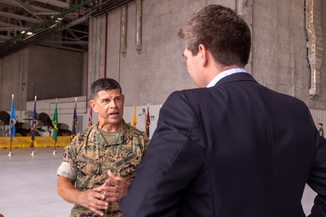 U.S. Marine Corps Maj. Gen. John F. Kelliher III, commanding general, 4th Marine Aircraft Wing, Marine Forces Reserve, speaks with Brian J. Flores, North Texas deputy regional director before a ceremony at Naval Air Station Joint Reserve Base Fort Worth, Texas, June 18, 2025. The ceremony celebrated Marine Transport Squadron (VMR) 1’s achievement of full operational capability with the C-40A aircraft, marking a significant milestone in squadron readiness and success. (U.S. Marine Corps photo by Cpl. Kanoa Thomas)