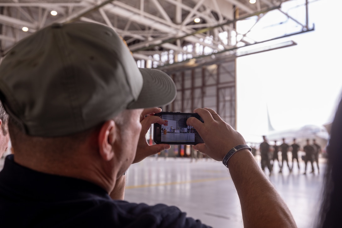 Joaquin Castillo, Fort Worth veterans’ affairs officer, takes a photo during Marine Transport Squadron (VMR) 1’s ceremony recognizing its classification as a full operational capability squadron at Naval Air Station Joint Reserve Base Fort Worth, Texas, June 18, 2025.  VMR-1’s achievement of full operational capability with the C-40A aircraft, marks a significant milestone in squadron readiness and success. (U.S. Marine Corps photo by Cpl. Kanoa Thomas)