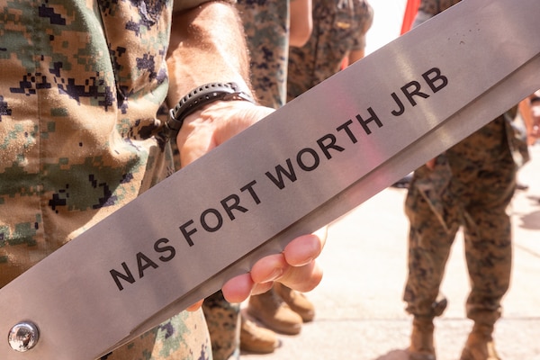 U.S. Marine Corps Lt. Col. Hanson W. Pitchford, commanding officer, Marine Transport Squadron (VMR) 1, Marine Aircraft Group 41, 4th Marine Aircraft Wing, Marine Forces Reserve, holds scissors used to cut a ribbon after a ceremony recognizing VMR-1’S classification as a full operational capability squadron at Naval Air Station Joint Reserve Base Fort Worth, Texas, June 18, 2025.  VMR-1’s achievement of full operational capability with the C-40A aircraft, marks a significant milestone in squadron readiness and success. (U.S. Marine Corps photo by Cpl. Kanoa Thomas)