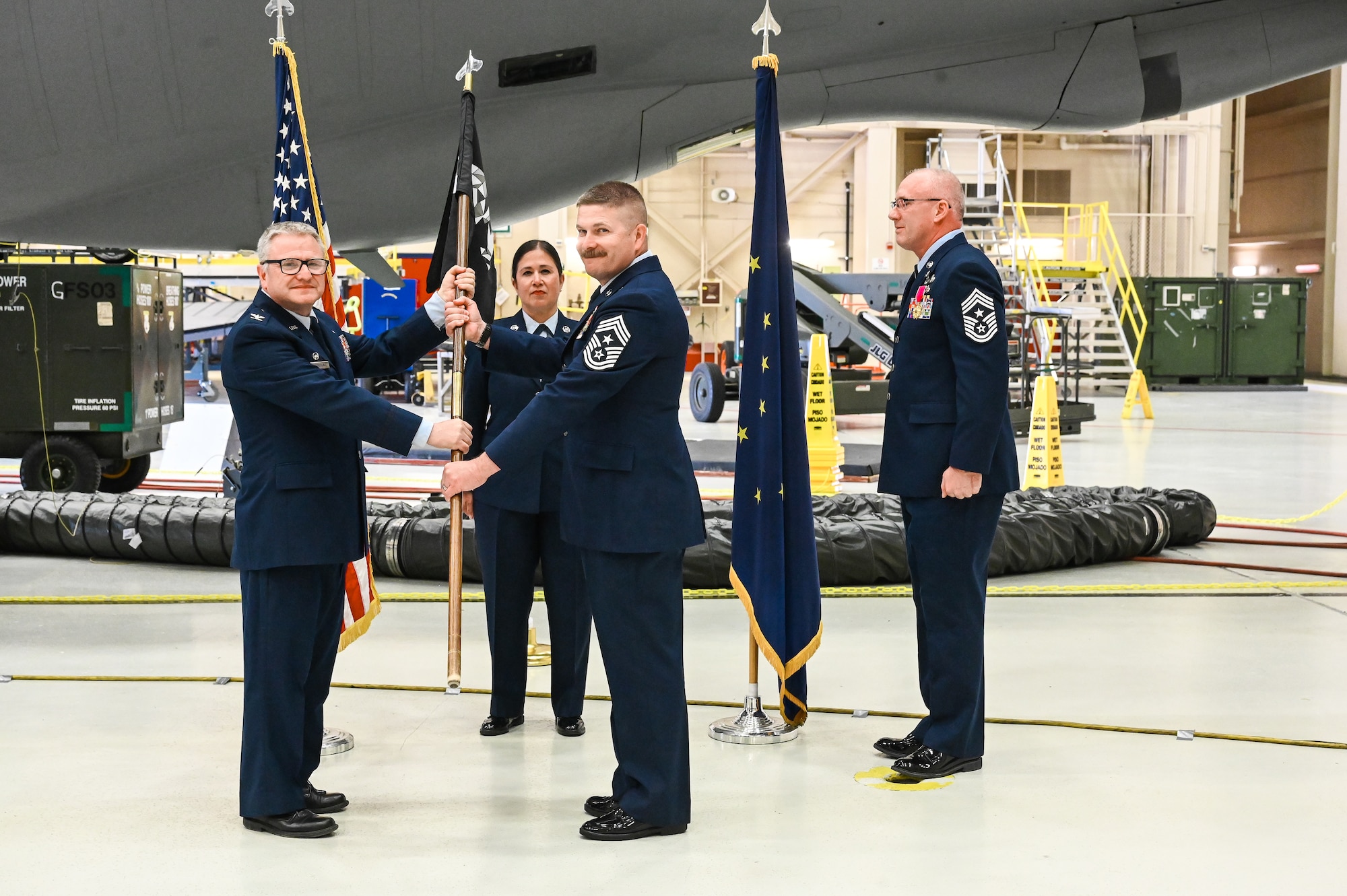 Command Chief Master Sgt. Raymond S. Allen, incoming command chief, receives the 168th wing polar bear guidon during the wing’s first-ever Change of Responsibility Ceremony Accepting the Polar Bear guidon and the responsibilities it represents, Chief Master Sgt. Raymond S. Allen now takes the helm as Command Chief. .