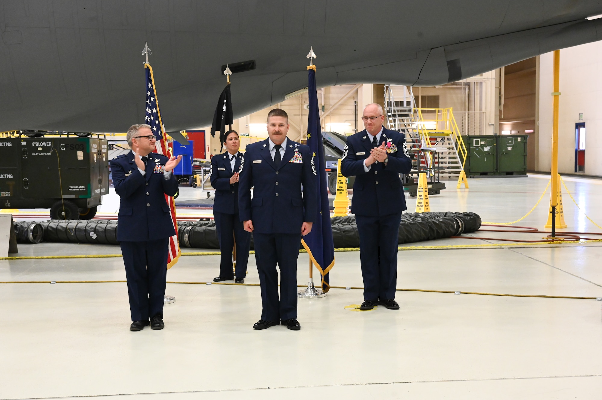 Command Chief Master Sgt. Raymond S. Allen, incoming command chief, receives the 168th wing polar bear guidon during the wing’s first-ever Change of Responsibility Ceremony.