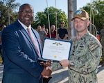 (right) Naval Surface Warfare Center Panama City Division Commanding Officer Capt. Paul Stence, Jr., awards Tommy Chatman with the Department of the Navy Civilian Service Achievement Medal, April 18. Chatman was a key contributor in acquiring the Standoff Reacquire Identify Detection Expeditionary Navigation Tool (STRIDENT) production contract for NSWC PCD. STRIDENT is a cutting-edge, long-range reconnaissance and targeting system that enhances the Navy's ability to identify and neutralize threats from a safe distance. (U.S. Navy photo by Anthony Powers)