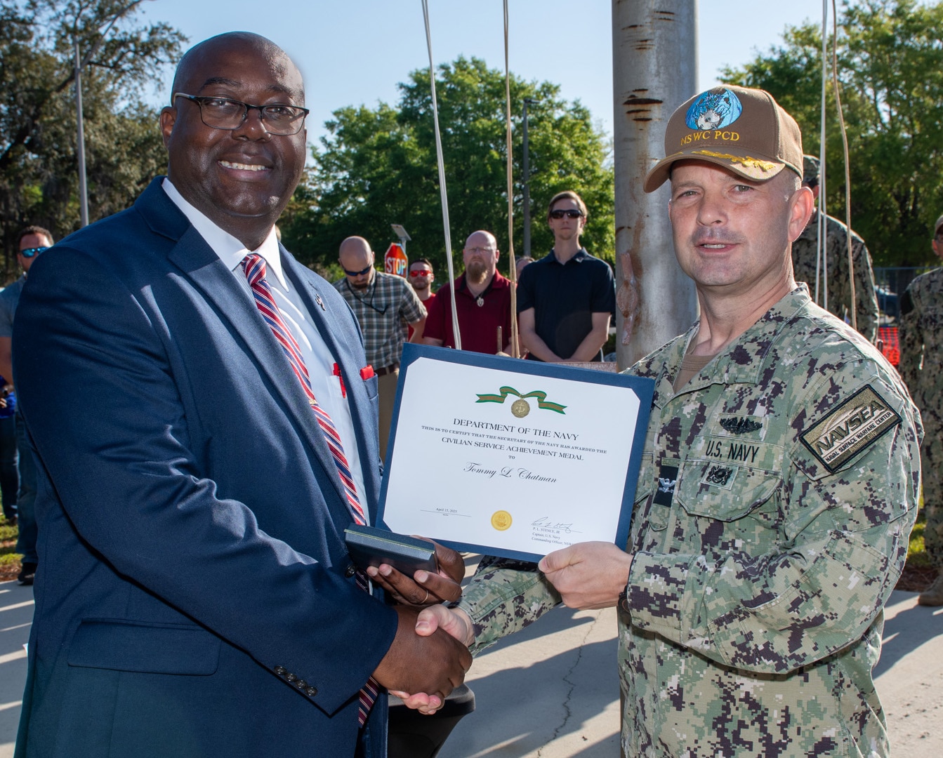 (right) Naval Surface Warfare Center Panama City Division Commanding Officer Capt. Paul Stence, Jr., awards Tommy Chatman with the Department of the Navy Civilian Service Achievement Medal, April 18. Chatman was a key contributor in acquiring the Standoff Reacquire Identify Detection Expeditionary Navigation Tool (STRIDENT) production contract for NSWC PCD. STRIDENT is a cutting-edge, long-range reconnaissance and targeting system that enhances the Navy's ability to identify and neutralize threats from a safe distance. (U.S. Navy photo by Anthony Powers)