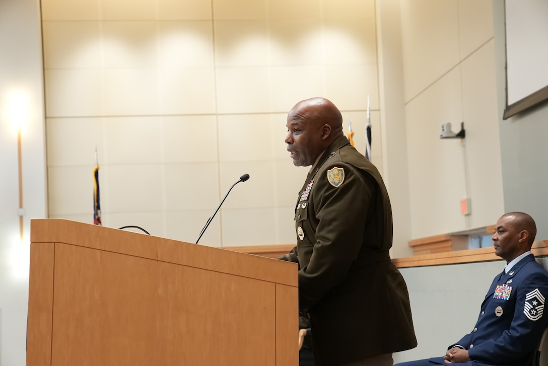 man in uniform speaks at podium