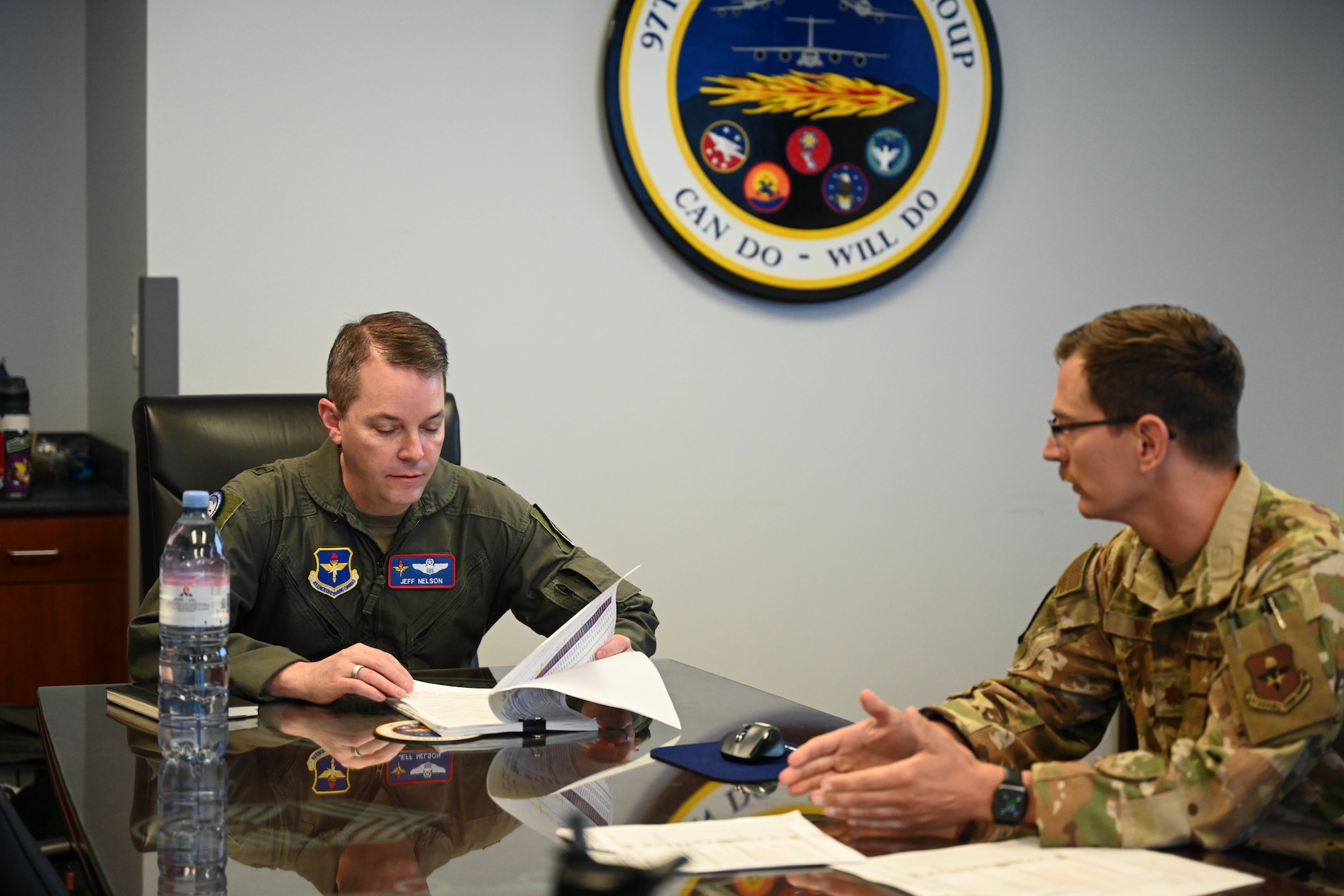 U.S. Air Force Brig. Gen. Jeffery Nelson, director of operations and communications for Air Education and Training Command, and Maj. Matt Way, 58th Airlift Squadron assistant director of operations, analyze documents at Altus Air Force Base, Oklahoma, June 9, 2025. Nelson met with members of the 97th Operations Group for his first stop at the installation. (U.S. Air Force photo by Airman 1st Class Lauren Torres)