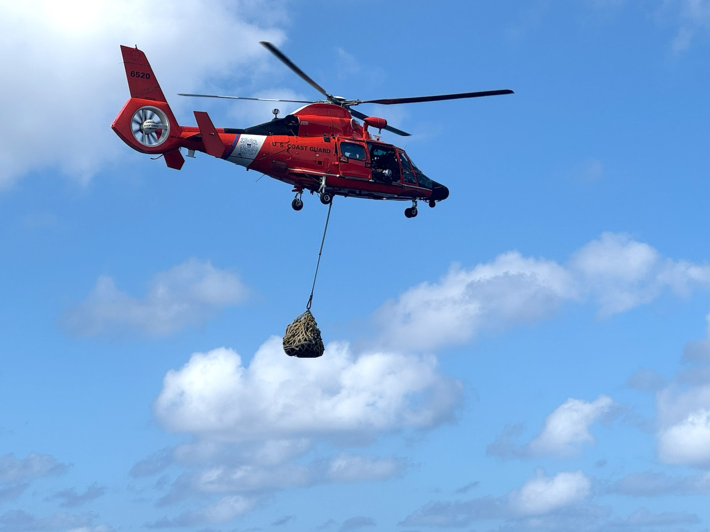 Coast Guard Cutter Campbell (WMEC 909) and an MH-65 Dolphin helicopter aircrew from the Coast Guard Helicopter Interdiction Tactical Squadron conduct helicopter operations near Miami, Florida, April 25, 2025. Campbell's crew conducted a two-month patrol to protect the safety of life at sea and deter illegal alien migration in the Windward Passage. (U.S. Coast Guard photo by Lt. j.g. Isabella Virzi)