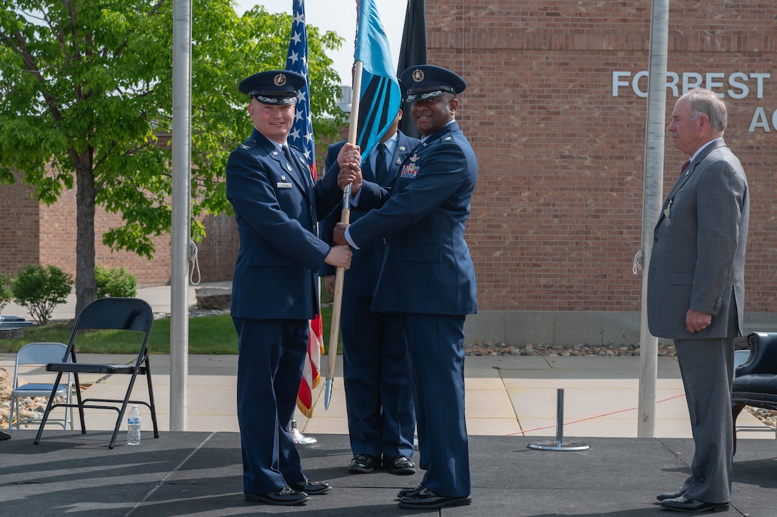 Men exchanging guidon