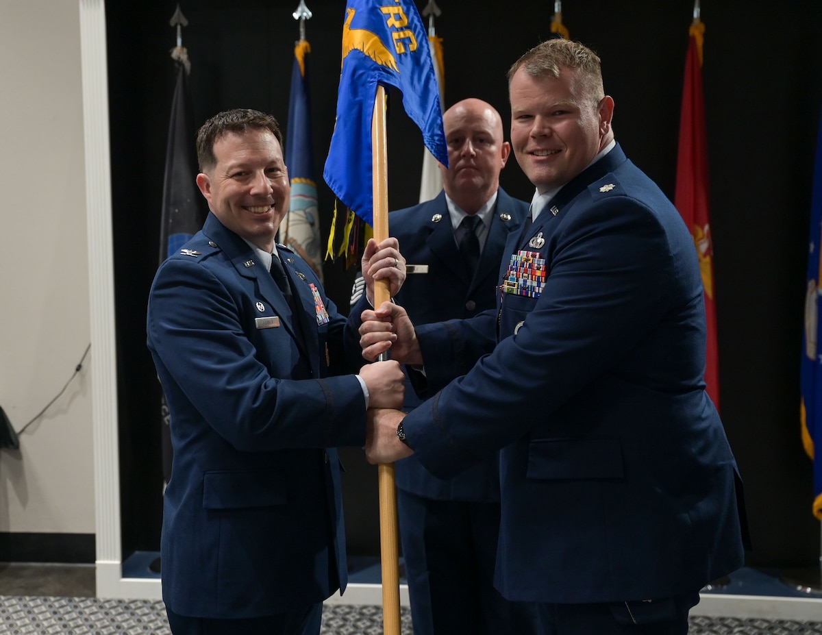 U.S. Air Force Col. Jason Gerber, 17th Training Group commander, takes the guidon from Lt. Col. Garrett Williams, outgoing 313th Training Squadron commander, during the change of command ceremony at the Powell Event Center, Goodfellow Air Force Base, Texas, June 18, 2025. Passing the guidon represents the transfer of leadership responsibilities to the next commander. (U.S. Air Force photo by Senior Airman Evelyn J. D’Errico)