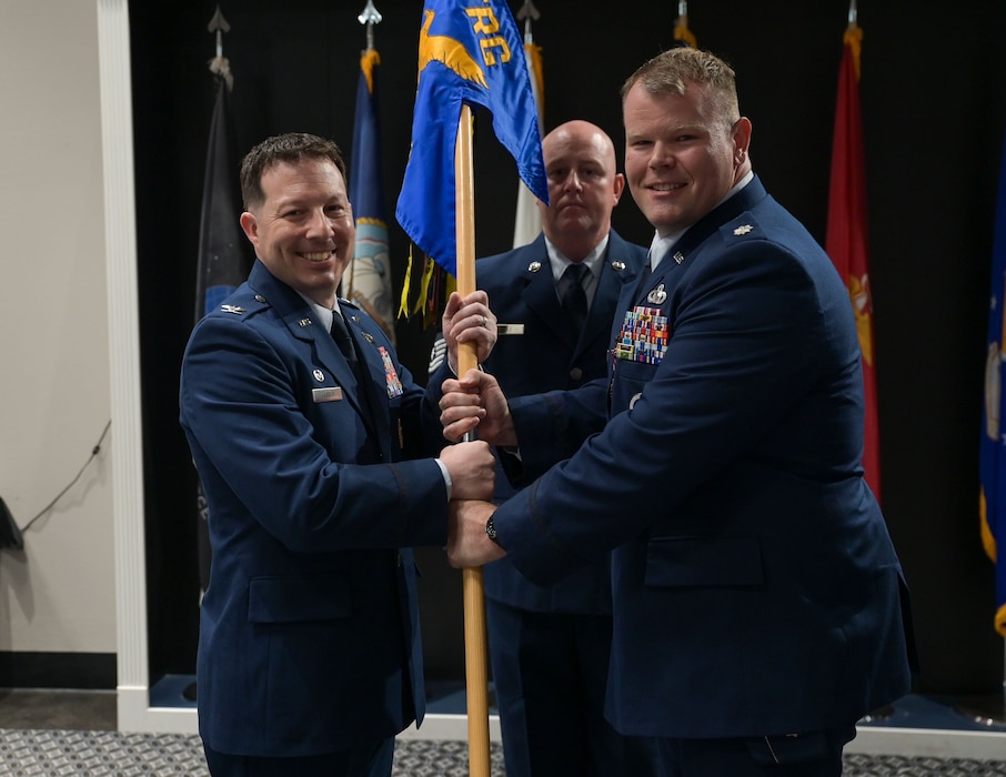 U.S. Air Force Col. Jason Gerber, 17th Training Group commander, takes the guidon from Lt. Col. Garrett Williams, outgoing 313th Training Squadron commander, during the change of command ceremony at the Powell Event Center, Goodfellow Air Force Base, Texas, June 18, 2025. Passing the guidon represents the transfer of leadership responsibilities to the next commander. (U.S. Air Force photo by Senior Airman Evelyn J. D’Errico)