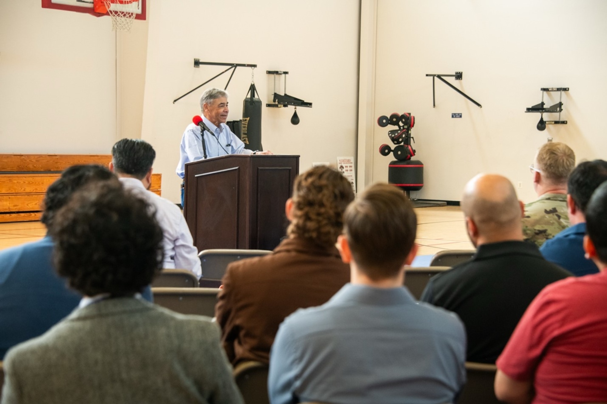 A veteran of acquisitions for over 50 years, Vern Edwards delivers a speech to a packed gym at Space Systems Command (SSC) May 29, 2025. Edwards returned to Los Angeles AFB to impart hard-earned wisdom to acquisitions professionals eager to learn from his celebrated career. (Space Force Photo:  Van Ha)
