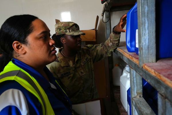 Staff Sgt. Tye Hendrix, center, unit health assessor of Pacific Partnership 2025 (PP-25), and a local public health technician conduct a public health tour of a local frozen confectionery production plant as part of PP-25 in Nuku’Alofa, Tonga, June 18, 2025.