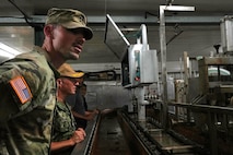 U.S. Navy Capt. Mark B. Stefanik, second from left, mission commander of Pacific Partnership 2025 (PP-25), and U.S. Army Capt. Levi Jackson, assigned to 72nd Medical Detachment Veterinary Service Support, conduct a public health tour of a local frozen confectionery production plant as part of PP-25 in Nuku’Alofa, Tonga, June 18, 2025.