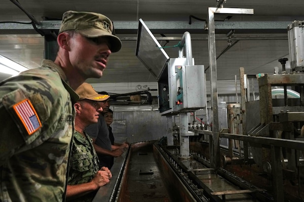 U.S. Navy Capt. Mark B. Stefanik, second from left, mission commander of Pacific Partnership 2025 (PP-25), and U.S. Army Capt. Levi Jackson, assigned to 72nd Medical Detachment Veterinary Service Support, conduct a public health tour of a local frozen confectionery production plant as part of PP-25 in Nuku’Alofa, Tonga, June 18, 2025.
