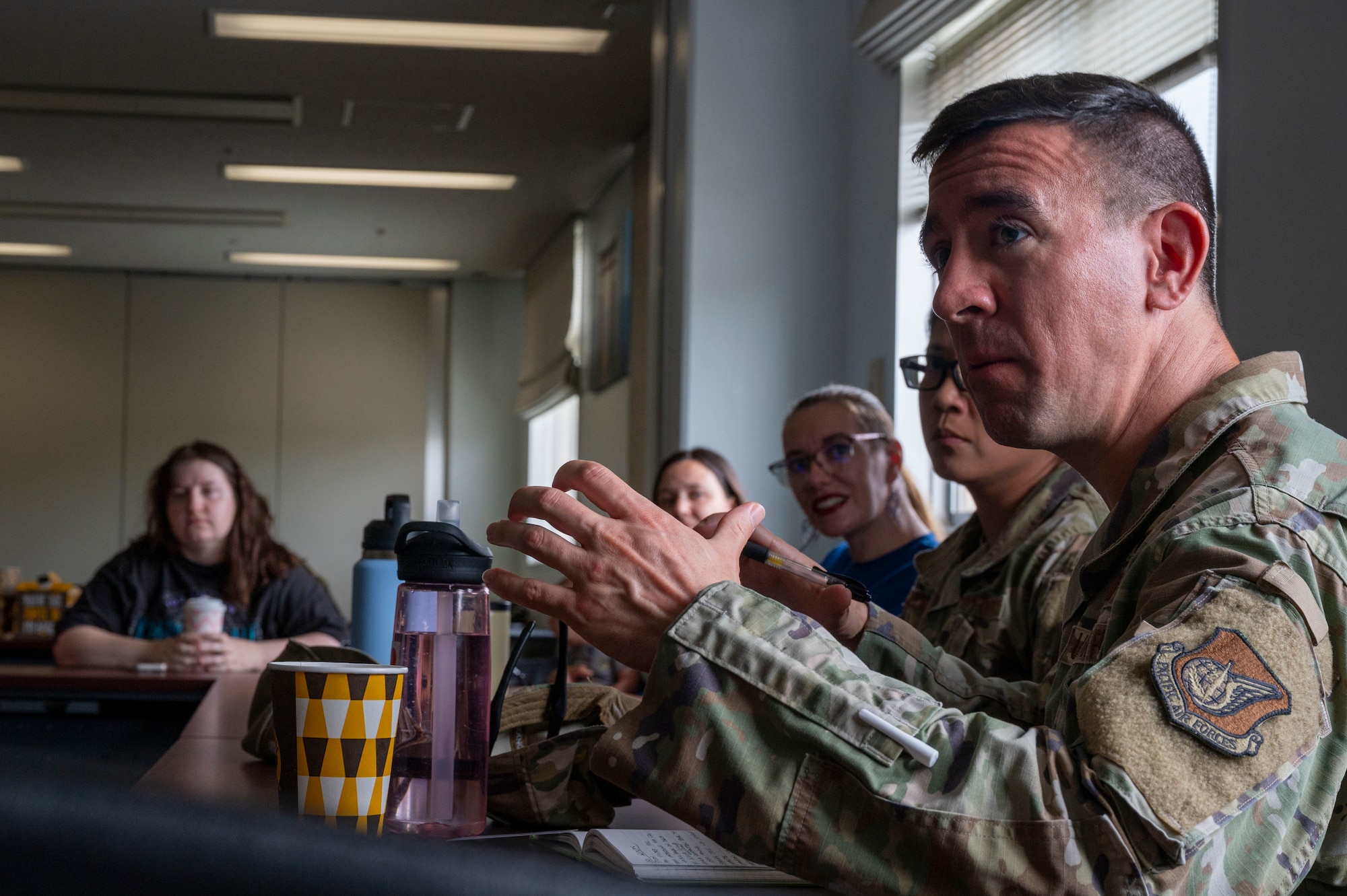 U.S. Air Force Maj. Robert Pukay-Martin, 374th Civil Engineer Squadron operations flight commander, speaks to attendees during a spouse coffee chat.
