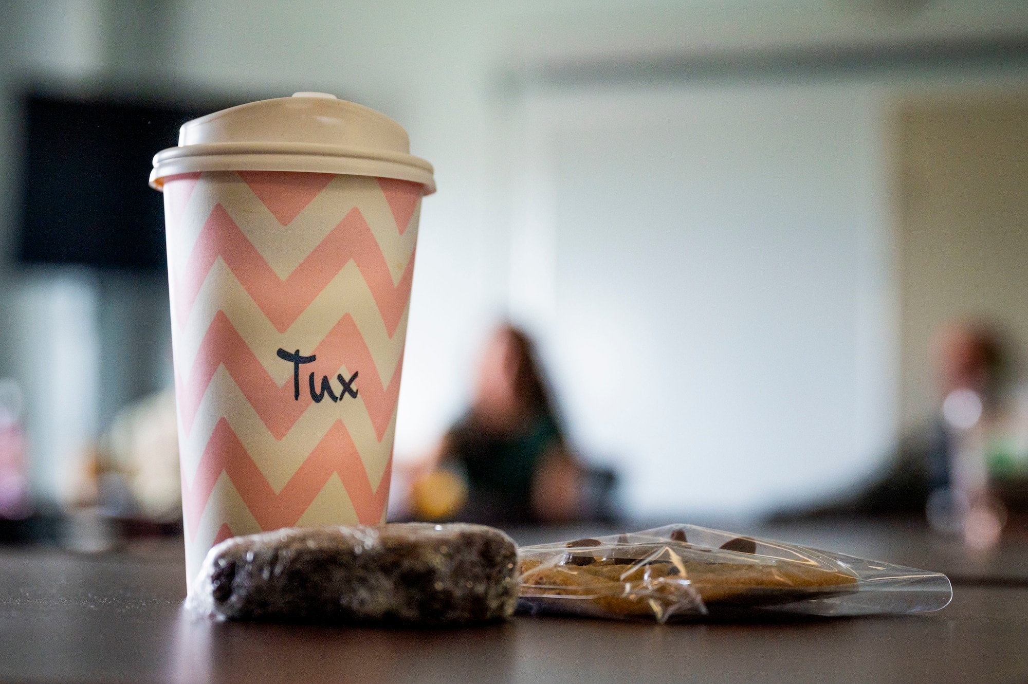 Coffee and snacks are displayed on a table.