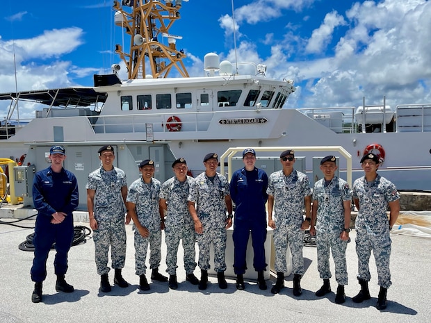 Lt. Emma Saunders, commanding officer of USCGC Myrtle Hazard (WPC 1139) and members of the Republic of Singapore Naval Diving Unit stand for a photo in Guam on June 11, 2025.