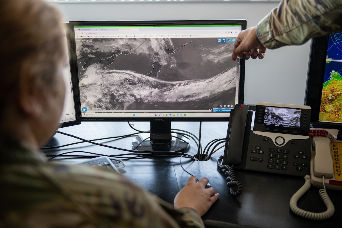 U.S. Air Force Senior Airman Leah Stafford, left, 35th Operations Support Squadron (OSS) weather forecaster, works with U.S. Air Force Staff Sgt. Elijah Tait, left, 35th OSS weather operations and planning noncommissioned officer in charge, to analyze radar and satellite imagery data.