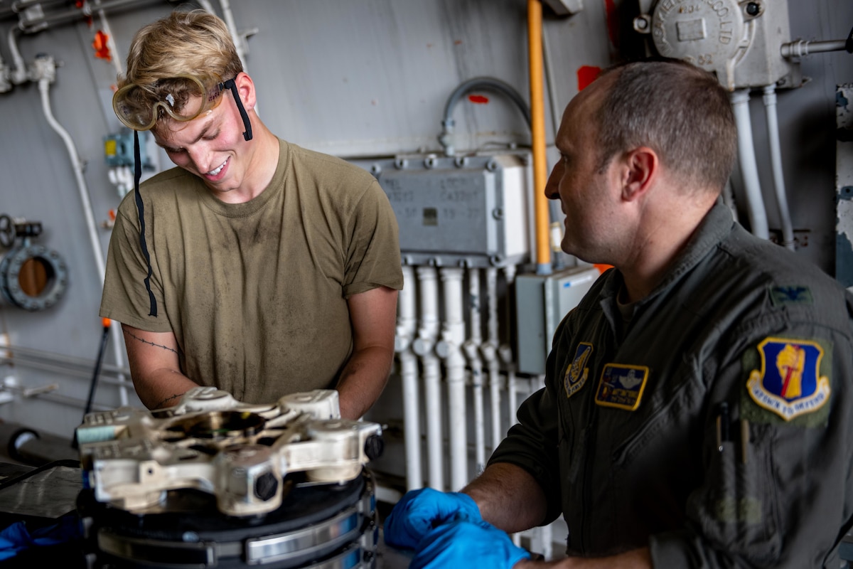 U.S. Air Force Senior Airman Derek Johnson, 14th Fighter Generation Squadron F-16 Fighting Falcon assistant dedicated crew chief, explains the steps to changing an F-16 brake pad to U.S. Air Force Col. Matthew Kenkel, 35th Fighter Wing deputy commander.