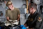U.S. Air Force Senior Airman Derek Johnson, 14th Fighter Generation Squadron F-16 Fighting Falcon assistant dedicated crew chief, explains the steps to changing an F-16 brake pad to U.S. Air Force Col. Matthew Kenkel, 35th Fighter Wing deputy commander.