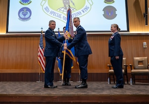 Guidon being passed to incoming commander.