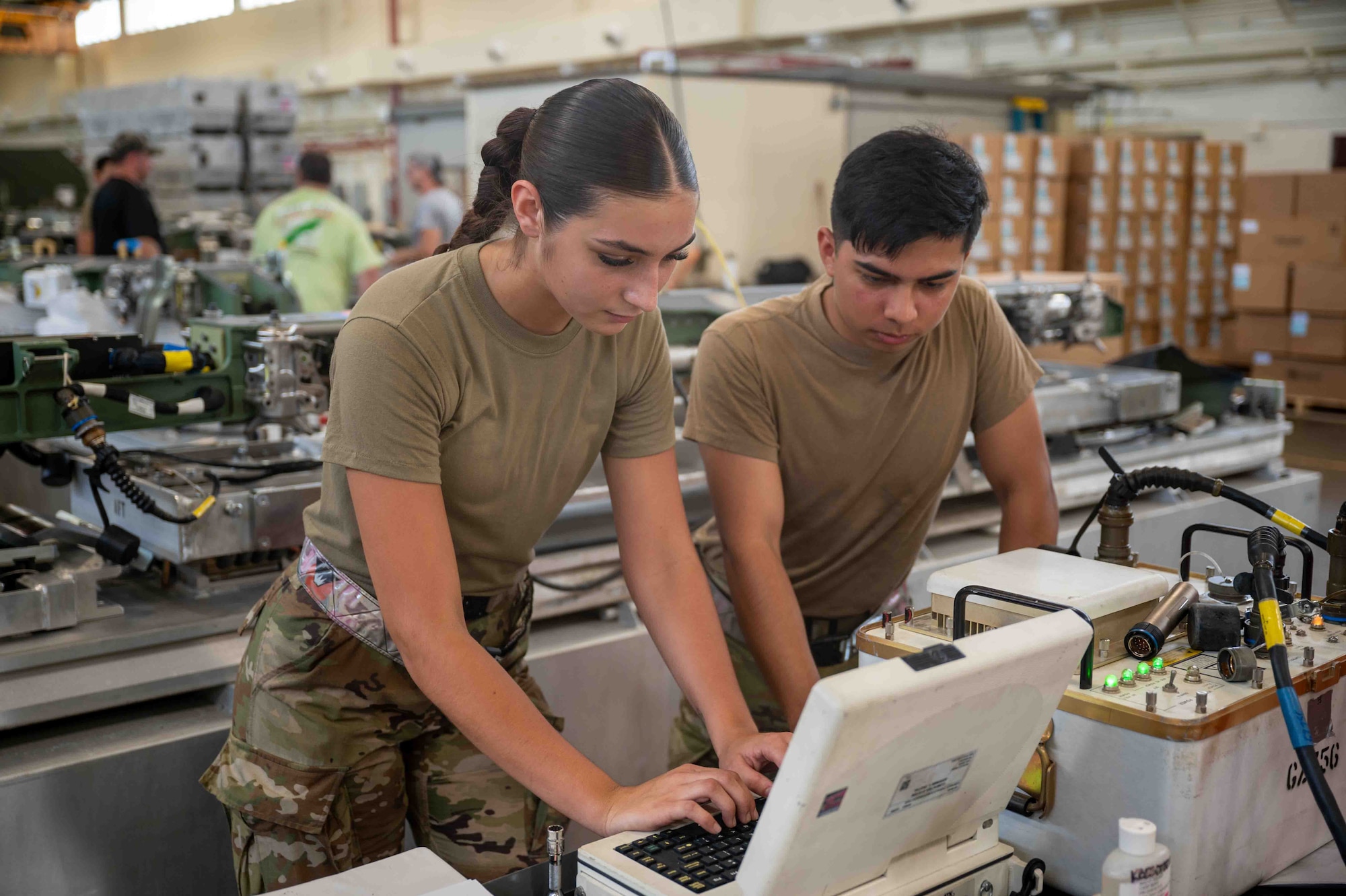 service members look at computer