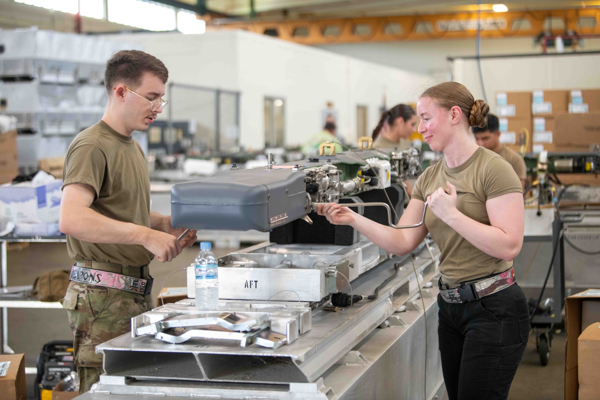 service members work on machine