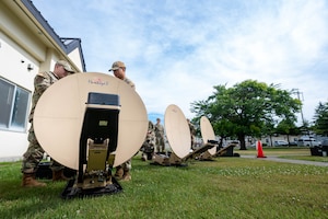 U.S. Air Force Airmen assigned to the 35th Communications Squadron troubleshoot a Hawkeye III Lite satellite system Rapid Response Communications Kit at Misawa Air Base, Japan, June 24, 2025.