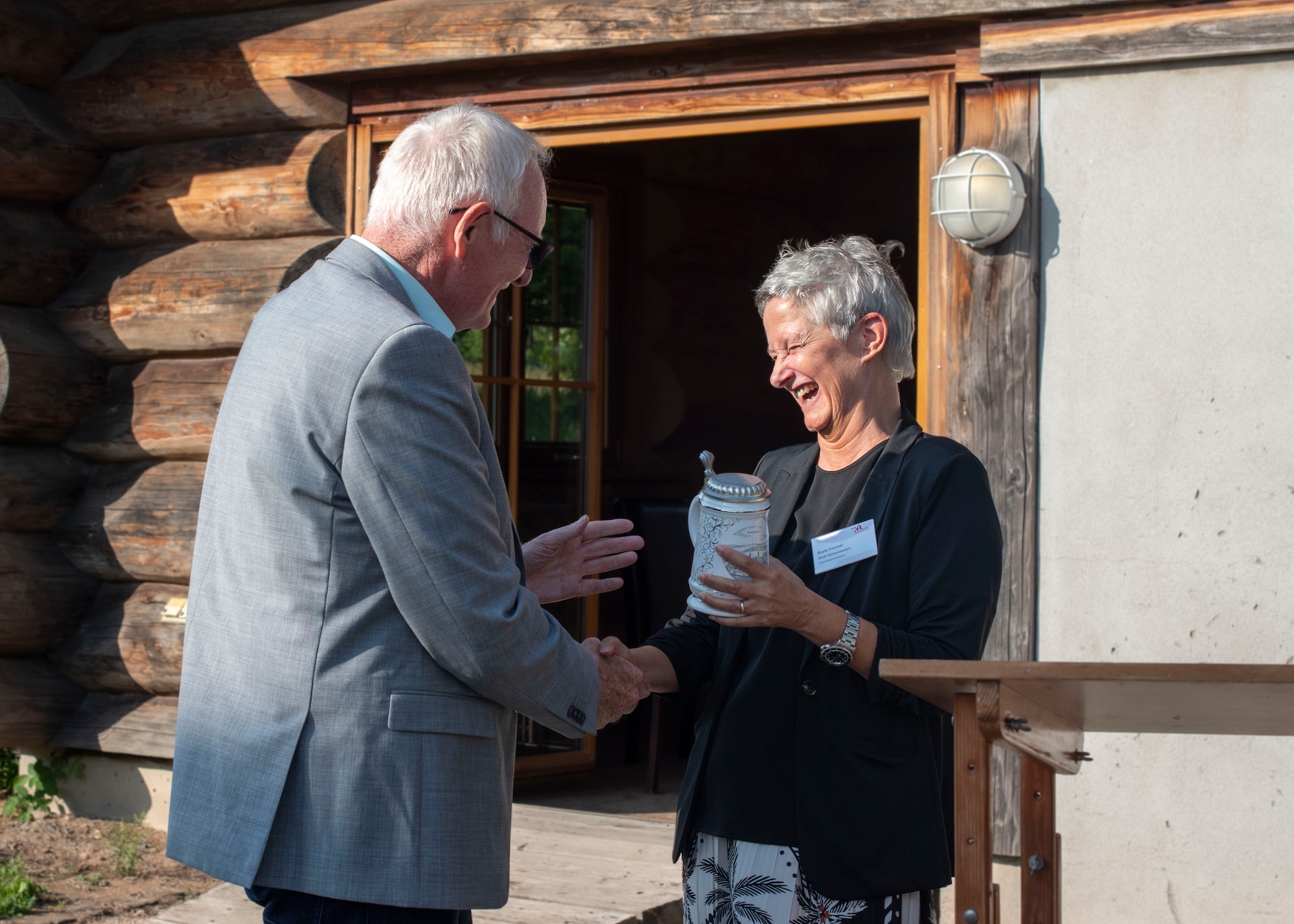 Mrs. Beate Kimmel, Lord Mayor of Kaiserslautern, gifts a traditional beer glass to Mr. Helmut Haufe, general manager of Theater Logistics Support Center - Europe during the Kaiserslautern Summer Social at the Gartenschau, Kaiserslautern, June 16, 2025. Haufe served for a total of 41 years as a national civilian employee to the U.S. Army. (U.S. Air Force photo by Senior Airman Sabrina Fuller-Judd)