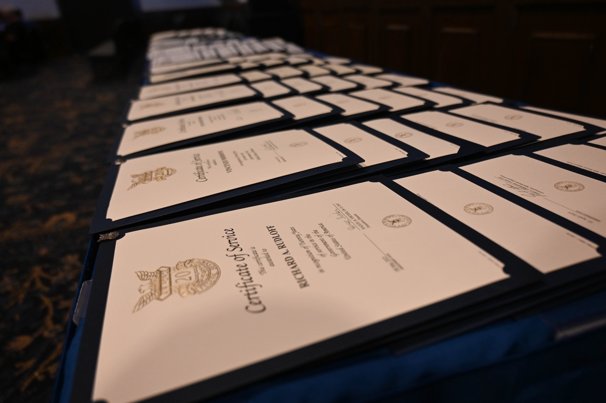 Awards of appreciation are displayed on a table during a Length of Service ceremony at Ramstein Air Base, Germany, June 17, 2025.