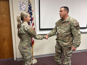 Maryland Air National Guard Brig. Gen. Drew E. Dougherty, assistant adjutant general – Air, shakes hands with Tech. Sgt. Tiffany Anstead, a recruiter for the 175th Wing, at Warfield Air National Guard Base at Martin State Airport, Maryland, May 3, 2025. Anstead was presented the Master Sgt. Salvador Torres Memorial Award at the end of her seven-week recruiting training in April, and was honored during the May regularly scheduled drill by Maryland National Guard leadership. (U.S. Air National Guard Photo by Maj. Benjamin Hughes)