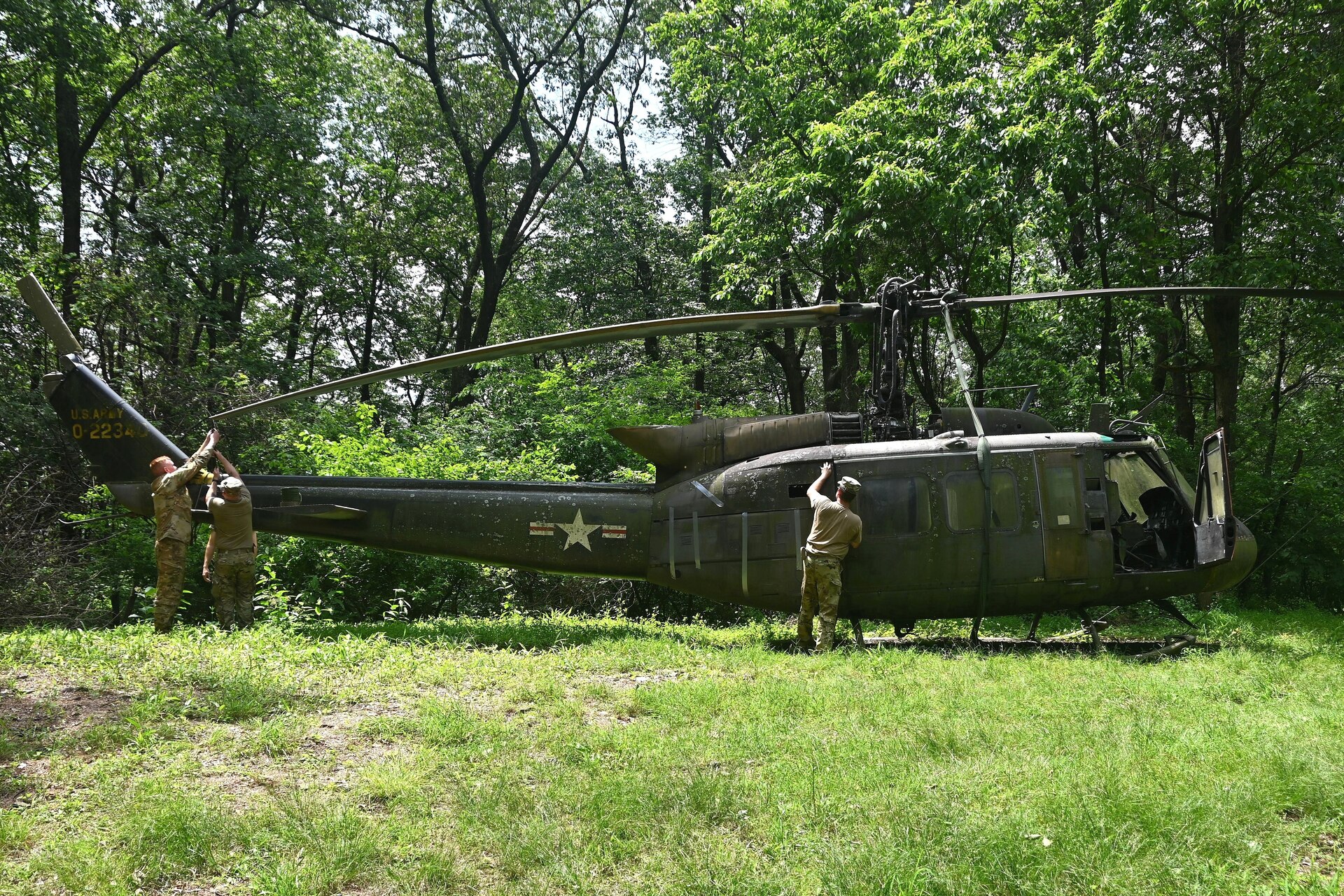 Soldiers from the 2-104th General Support Aviation Battalion, 28th Expeditionary Combat Aviation Brigade prepare a decommissioned UH-1 “Huey” helicopter to be air-lifted from the top of a mountain near Fort Indiantown Gap, Pennsylvania, to the installation June 20, 2025. (Pennsylvania National Guard photo by Brad Rhen)
