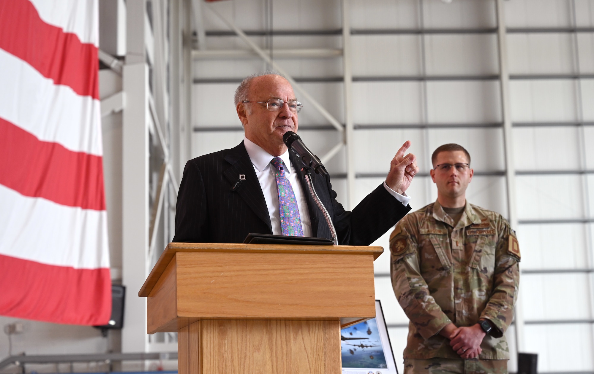 Steve Crosby, left, son of then-1st Lt. Harry Crosby, World War II and 100th Bomb Group navigator, shares some of his father’s dramatic memories of the Bremen mission during World War II, taken from Harry’s mission report and letters to his wife Jean, during a nose art unveiling ceremony at RAF Mildenhall, England, June 9, 2025. The nose art, “Just-A-Snappin,” displayed on a KC-135 Stratotanker belonging to the 100th Air Refueling Wing, pays homage to the crew of the World War II B-17 Flying Fortress of the same name, which included Steve’s father. (U.S. Air Force photo by Karen Abeyasekere)