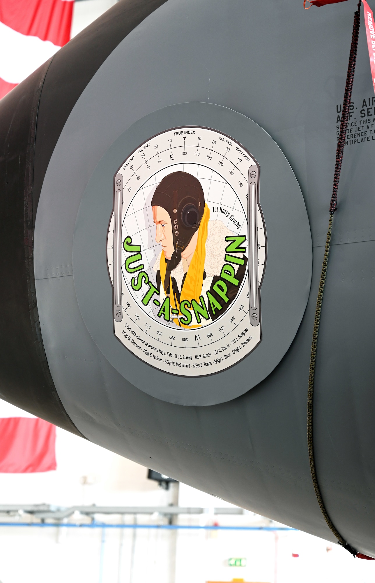 The latest 100th Air Refueling Wing legacy nose art, “Just-A-Snappin,” which is displayed on a KC-135 Stratotanker, focuses on the profile of renowned World War II and 100th Bomb Group navigator, then-1st Lt. Harry Crosby, and incorporates a background of a navigator’s dead-reckoning computer, and the names of the entire crew who flew the Bremen mission over Germany in October 1943. The nose art, designed by Gary Rogers, 100th ARW Public Affairs graphic designer, is the latest addition to the 100th ARW’s nose art collection on the fleet of KC-135 Stratotankers, which honors the Bloody Hundredth legacy. (U.S. Air Force photo by Karen Abeyasekere)