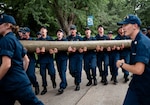 U.S. Coast Guard Cadets carry a log during sea trials at the Academy, New London, Conn., Aug 17, 2024. Sea Trials is a set of daylong exercises that challenges swabs physically and mentally, while also marking the conclusion of the summer training program. (U.S. Coast Guard photo by Petty Officer 3rd Class Matt Thieme.)