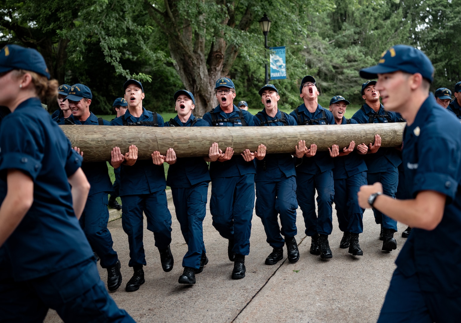 U.S. Coast Guard Cadets carry a log during sea trials at the Academy, New London, Conn., Aug 17, 2024. Sea Trials is a set of daylong exercises that challenges swabs physically and mentally, while also marking the conclusion of the summer training program. (U.S. Coast Guard photo by Petty Officer 3rd Class Matt Thieme.)