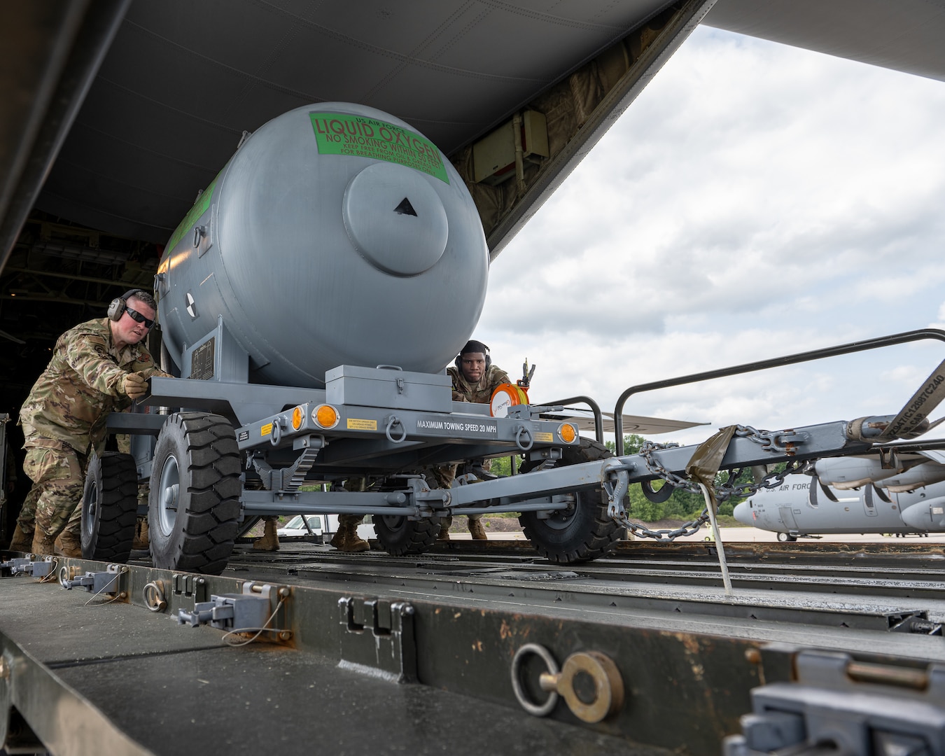U.S. Air Force Master Sgt. Jaron Bridges, left, 126th Air Transportation, 126th Logistics Readiness Squadron, U.S. Air National Guard, Scott Air Force Base, Illinois and Airman 1st Class Isaiah Mango, Ramp Specialist, 721st Aerial Port Squadron, U.S. Air Force, Ramstein Air Base, Germany offload a liquid oxygen tank from a C-130 onto a 60K Tunner at Ramstein AB June 9, 2025.