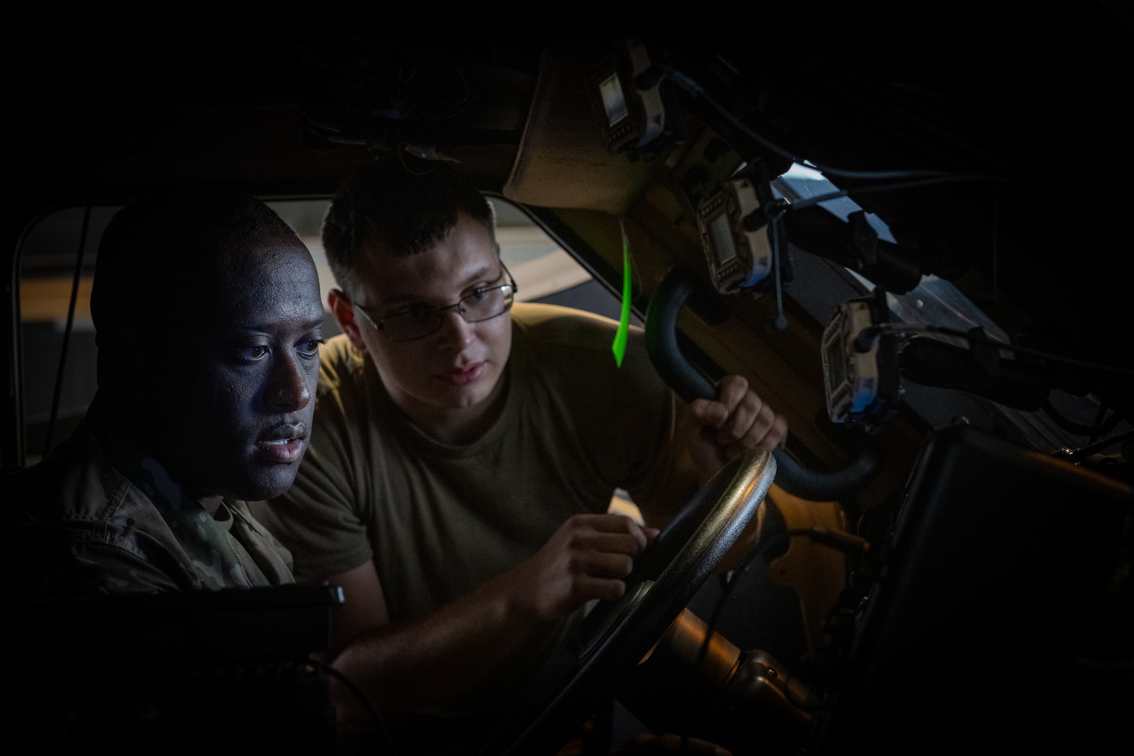 U.S. Air Force Airman 1st Class Chace Stewart, right, 126th Vehicular Equipment Maintenance, leads a training session at Ramstein Air Base, Germany with Master Sgt. Darien Jacobs, 1st Sergeant, 126th Logistics Readiness Squadron, 126th Air Refueling Wing, Scott Air Force Base, Illinois.